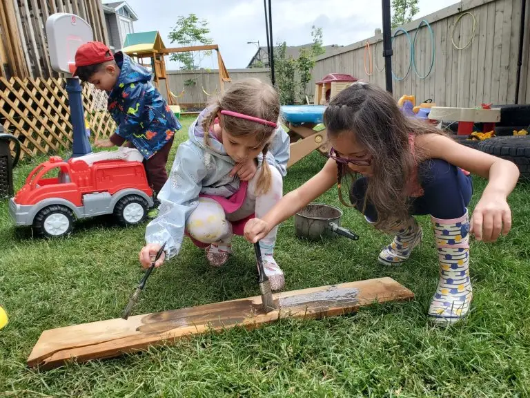 children painting outdoors