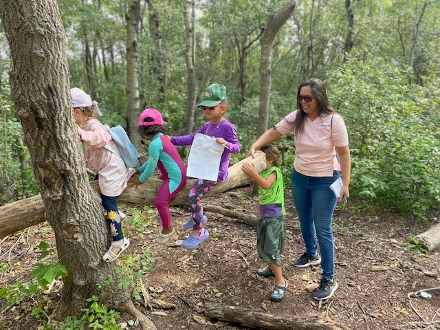 Children and educator outdoors in nature