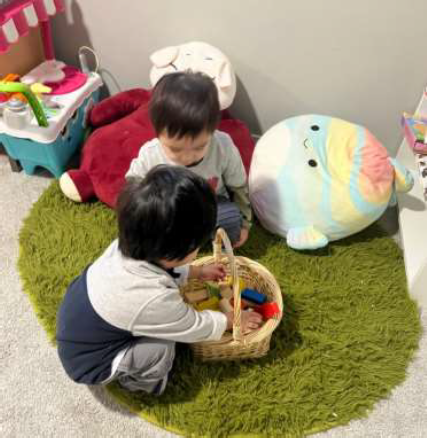 boy reaching for blocks in basket