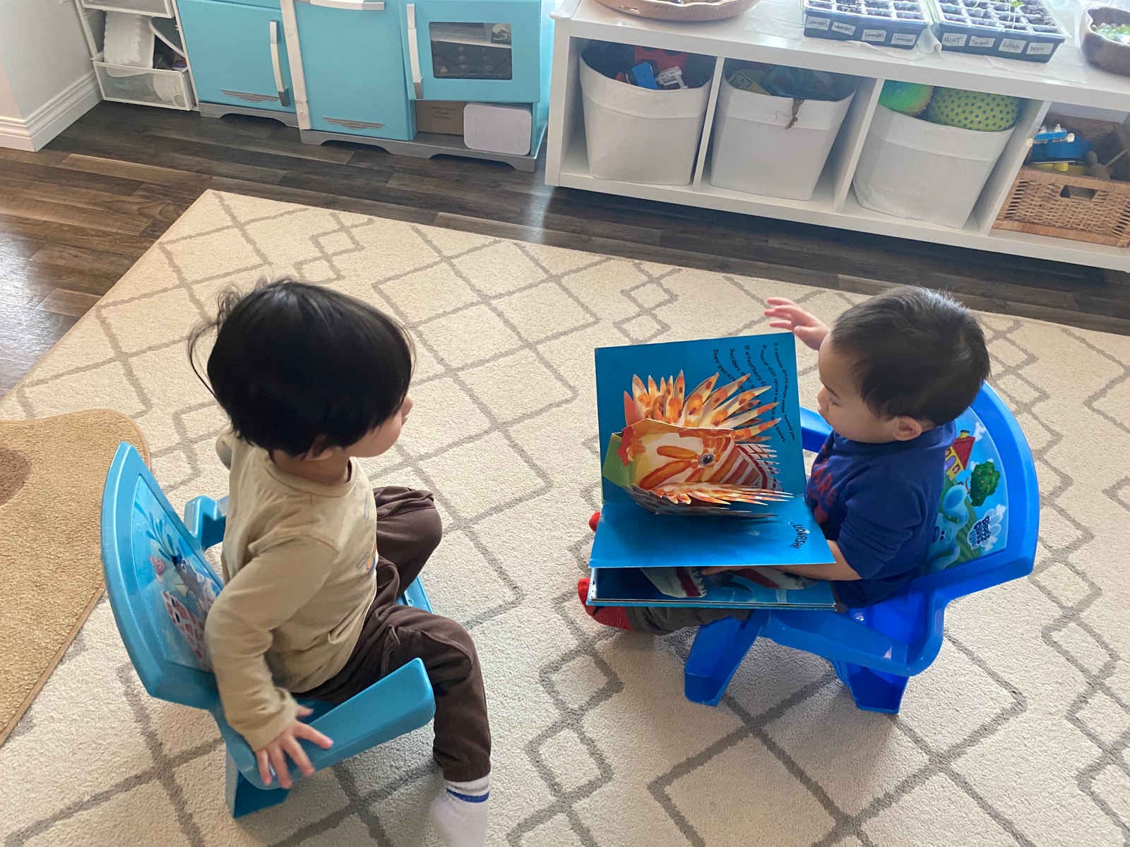 child reading a book to another child