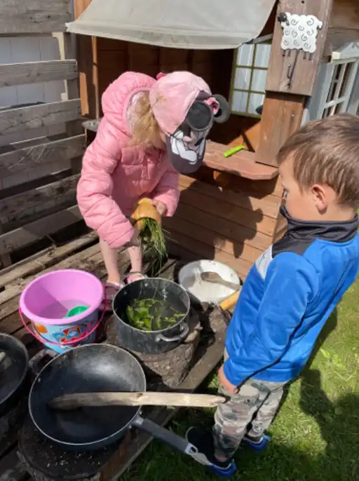 children playing in a mud kitchen