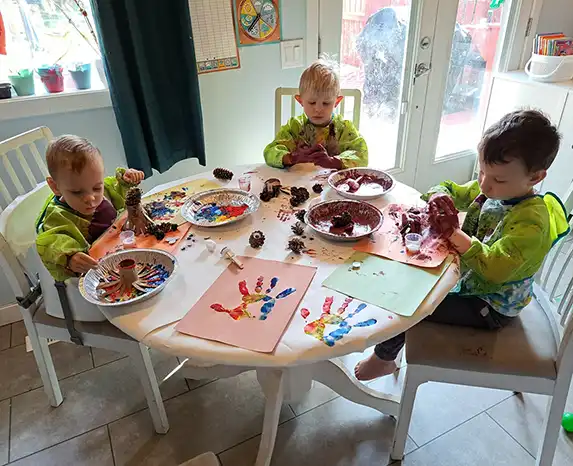 Dayhome children doing crafts at a table