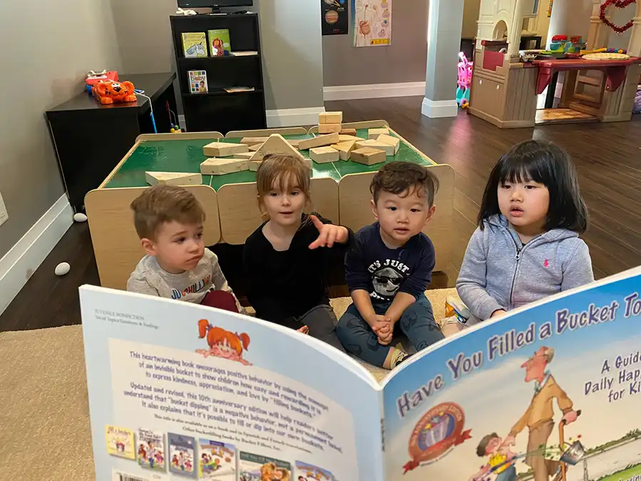 Children reading an oversized book at a dayhome