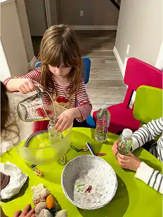 girl pouring water into a bottle